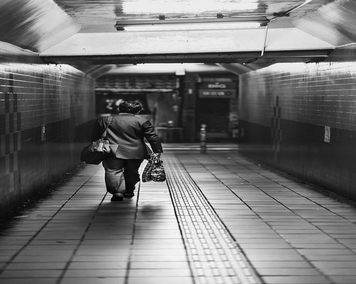Commuters in TransMilenio station walking lightly and respectfully